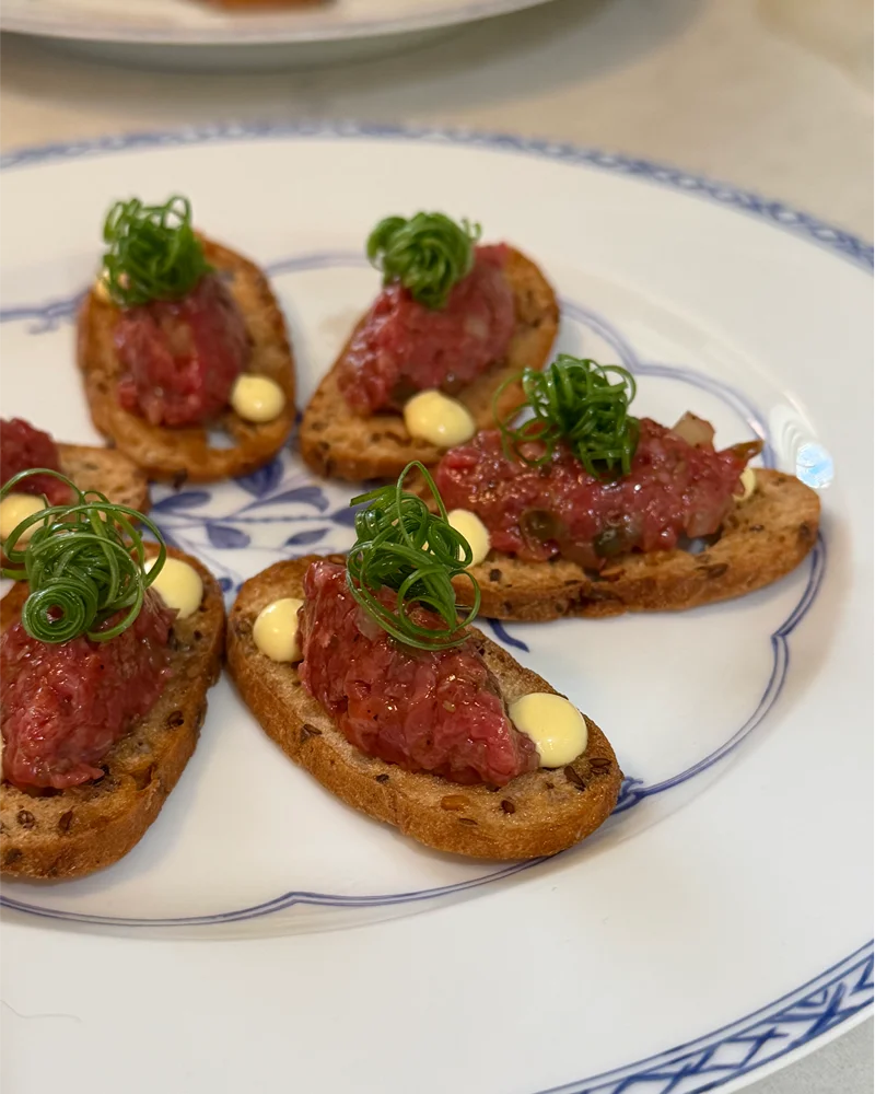 Steak tartare canapés on vintage china